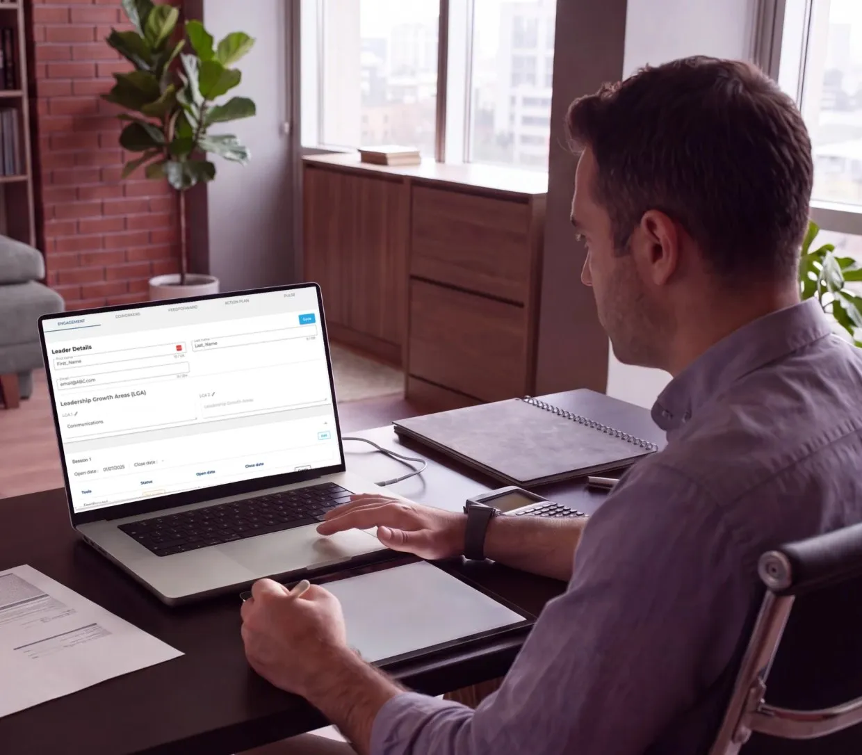 Leadership coach using the Triple Win Coaching Platform on a laptop.