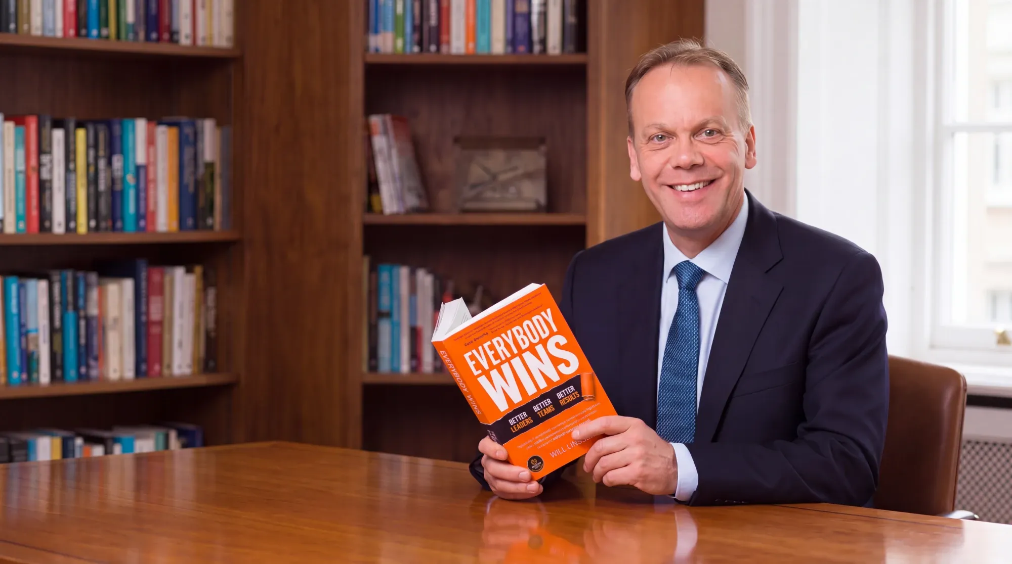 Will Linssen holding a copy of Everybody Wins